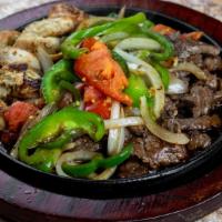 Mixed Fajitas · Beef and Chicken fajitas with tomatoes, peppers, and onions. Served with Spanish rice, refri...