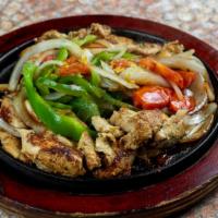 Chicken Fajitas · Chicken fajitas served  with tomatoes, peppers and onions. Accompanied with Spanish rice, re...