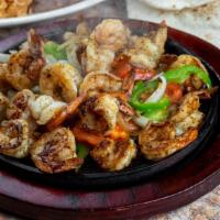 Shrimp Fajitas · Shrimp fajitas with tomatoes, peppers, and onions. Served with Spanish rice, refried beans, ...