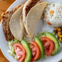 Blackened Fish Or Shrimp Tacos · Two blackened fillet of white fish or shrimp tacos served in handmade corn tortillas. Garnis...