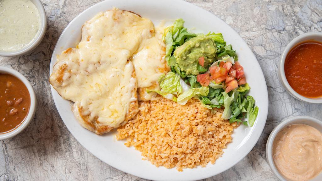 Pollo En Salsa · Two grilled chicken breasts topped with your choice of salsas and queso Chihuahua. Served with Spanish rice, frijoles a la charra, and guacamole salad. Choose from creamy poblano pepper, spicy chipotle pepper, or ranchero sauce.

*Entrée comes with 1 tortilla.