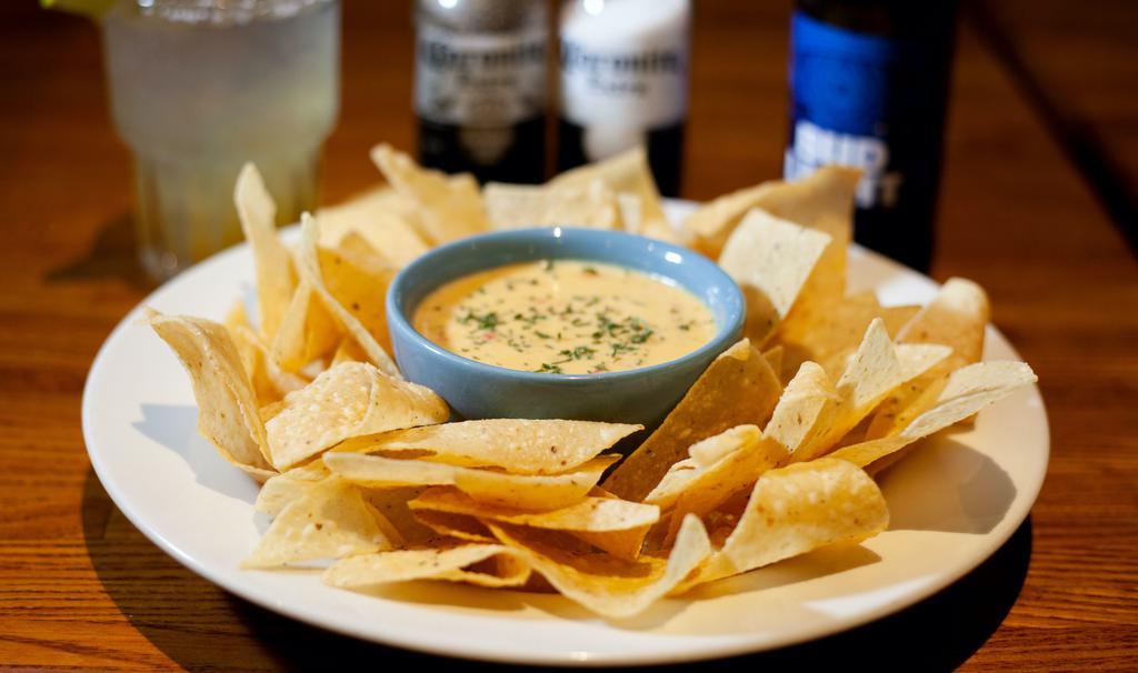 Chips & Queso · Our house blend of melted cheese topped with Pico De Gallo. Load 'em up! Add sour cream, ground beef, and guacamole for an additional charge.