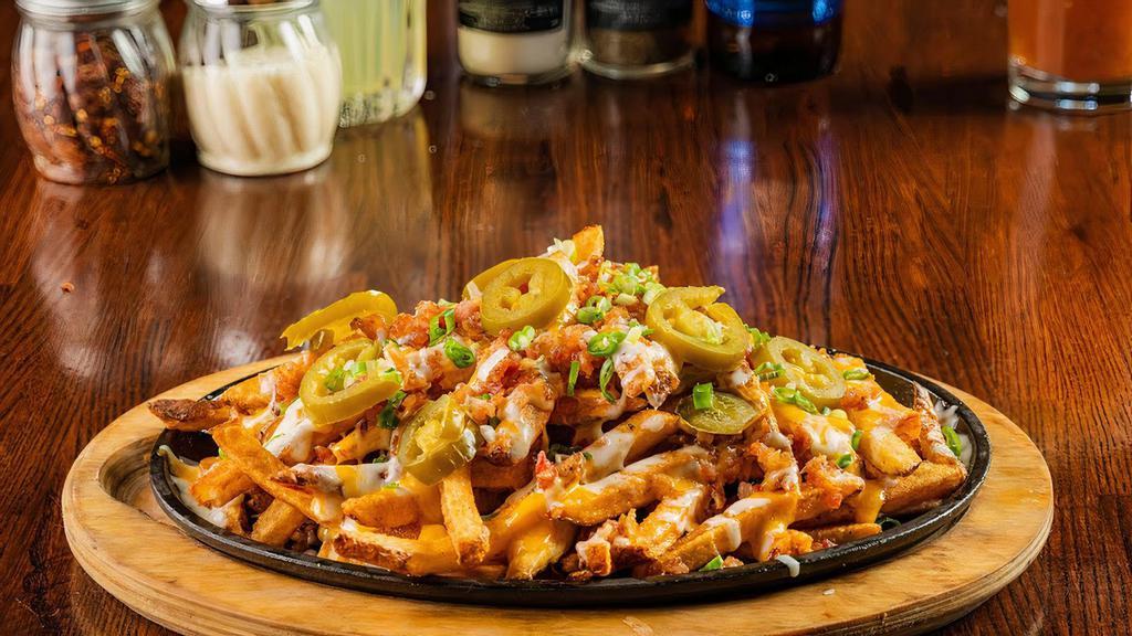 Back 9 Loaded Fries · Mixed Cheeses, Bacon, Chives, & Jalapeños. Served with Ranch Dressing.
