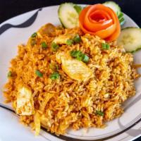 Ls15. Fried Rice · Stir-fried rice with tomatoes, onions, and egg in Thai style sauce.