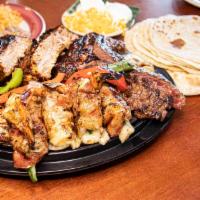 Enormo Mixed Grill · Comes with rice and beans, tortillas, cheese, sour cream, ribs, Acapulco shrimp, steak and c...
