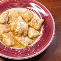 Sopapillas With Honey Butter Sauce · bite sized puffy pillows , confectioners - sugar and  dark chocolate dusting, honey butter s...