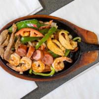 Parrillada Con Ganas · Mixed beef, chicken, shrimp and sausage with onions, tomato and bell pepper. Served with ric...