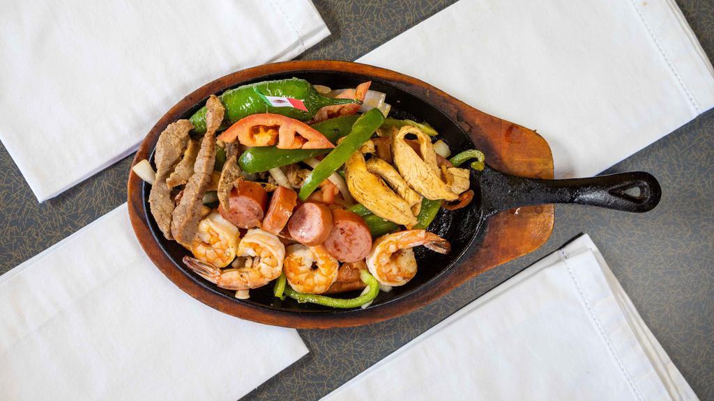 Parrillada Con Ganas · Mixed beef, chicken, shrimp and sausage with onions, tomato and bell pepper. Served with rice, beans and homemade corn tortilla.