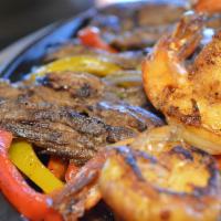 Fajitas Texanas (Lunch) · A combination of chicken, steak, and shrimp. Served with onions, tomatoes, bell peppers, let...