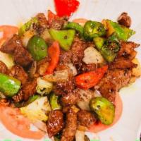 Shaking Beef · juicy beef cubes seasoned with pepper and sautéed until medium rare with garlic and bell pep...