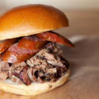 The Gut Buster Sandwich · Brisket, Pulled Pork & choice of Pork & Beef or Jalapeño & Beef Smoked Akaushi Sausage,  wit...