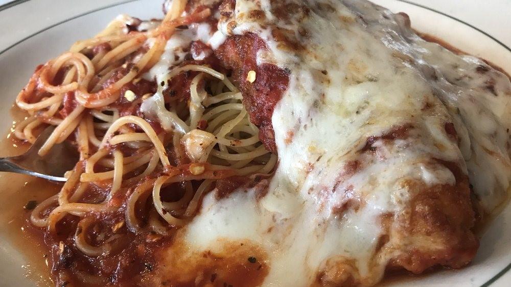 Chicken Parmigiana · Chicken topped with marinara sauce and mozzarella cheese over spaghetti.