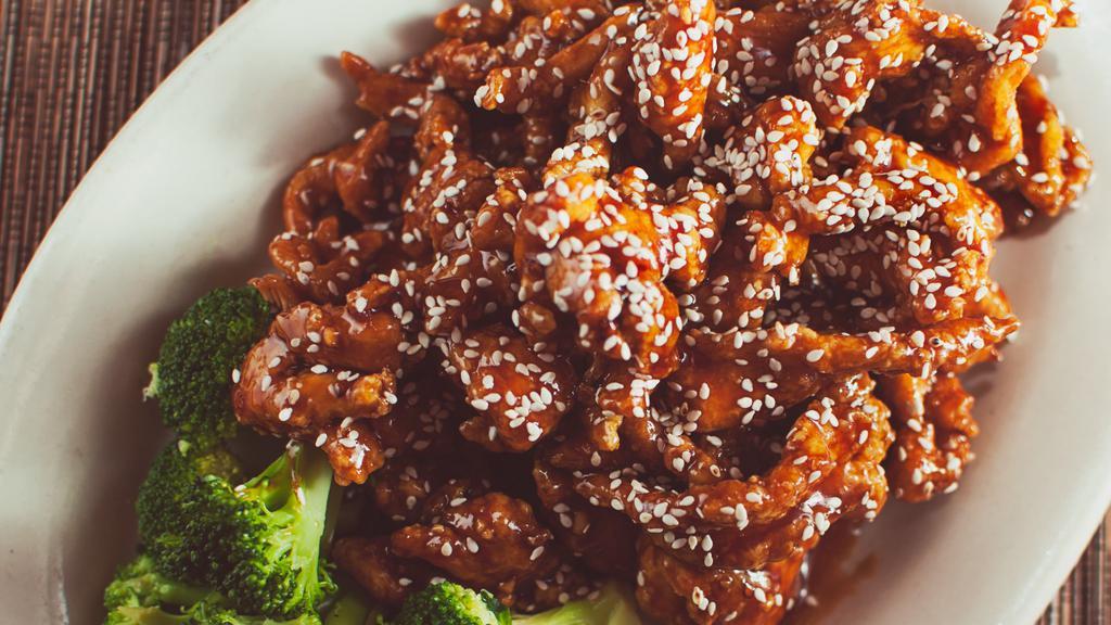 Sesame Chicken · Scrumptious strips of all white-meat chicken coated in garlic crumb, fried crispy, then tossed in a sweet, savory sesame glazed, with sesame seed sprinkles on top.