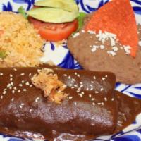 Mole Enchiladas · [2] Chicken Enchiladas topped with rich, savory Mole Sauce. Served with Spanish Rice and Ref...