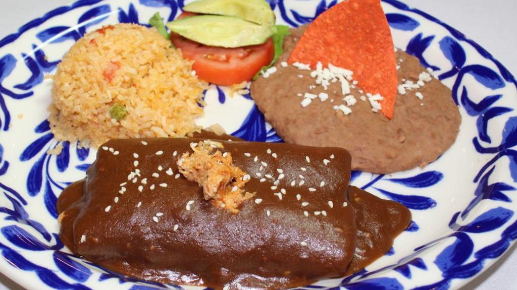 Mole Enchiladas · [2] Chicken Enchiladas topped with rich, savory Mole Sauce. Served with Spanish Rice and Refried Beans