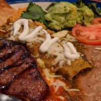 Steak And Enchilada · Ribeye Steak served with Cheese Enchilada, Spanish Rice and Refried Beans