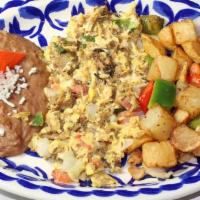 Machacado · Our famous Homemade tender shredded Mexican Style Beef Jerky scrambled with Eggs, Tomatoes, ...