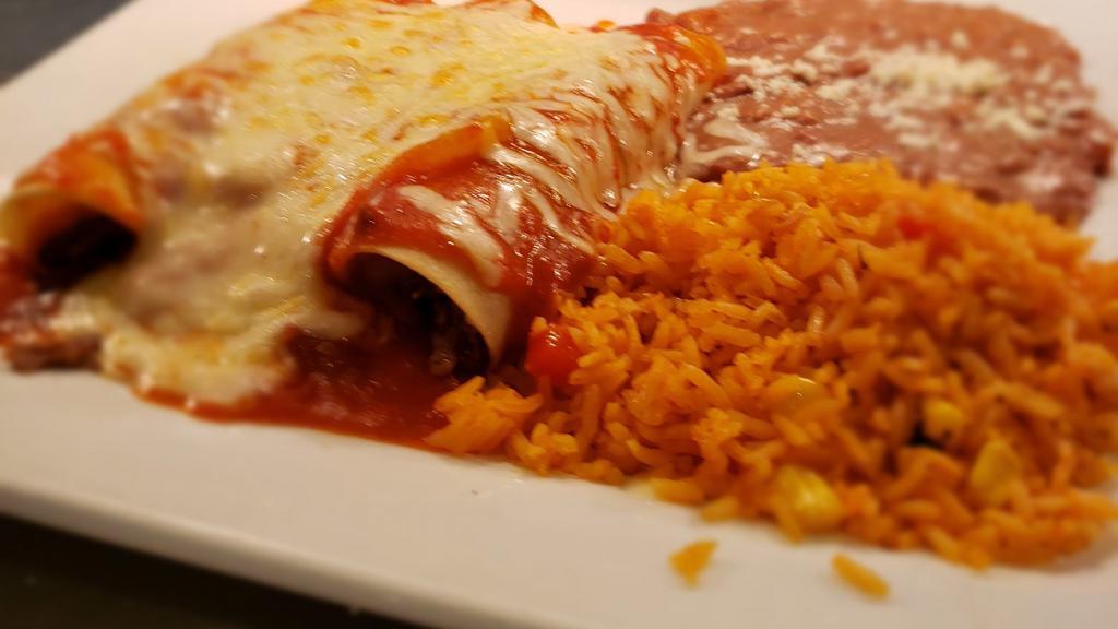 Enchiladas Mexicana · Two sautéed beef fajita enchiladas topped with ranchero sauce. Served with rice and refried beans.