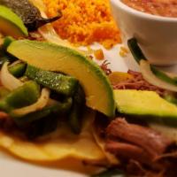 Brisket Tacos · Three soft corn tortillas topped with slow roasted brisket,green onions, monterey cheese and...