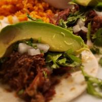 Barbacoa Tacos · Three braised lean beef cheek with corn tortillas. Served with cilantro, onions, avocado, ri...