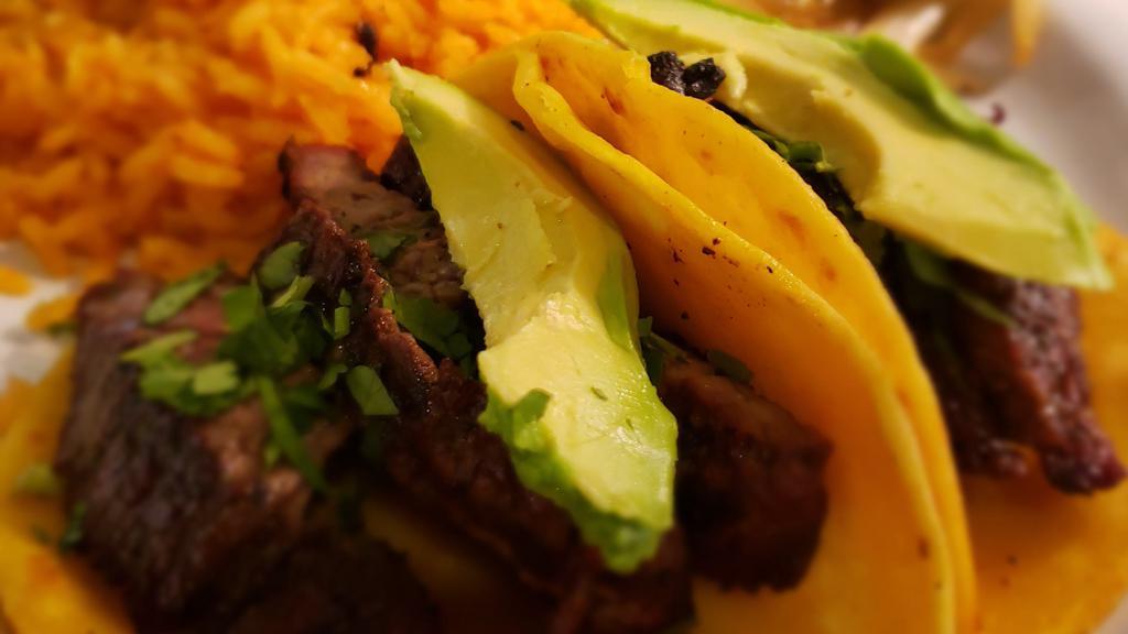 Calle Tacos · Three soft corn tortillas topped with fajita beef or fajita chicken, served with  cilantro and onions, avocado, rice and charro beans.