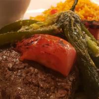 Carne Asada · Grilled steak over onions, peppers, tomatoes, and jalapenos. Served with rice and charro bea...
