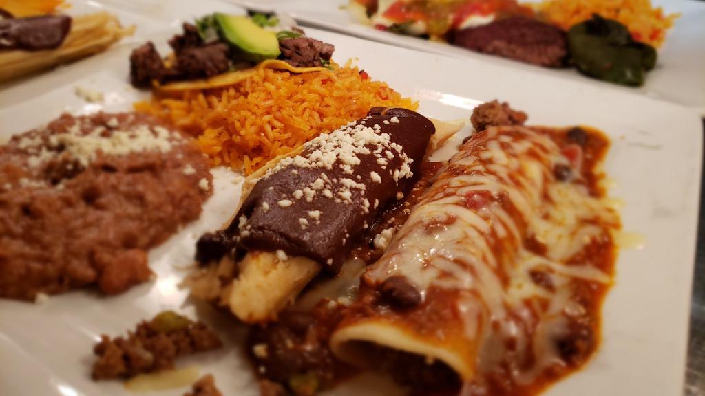 Chepe'S · Steak sopes, chicken enchilada with sour cream sauce and tomatillo sauce, and roasted poblano tamale. Served with rice and refried beans.