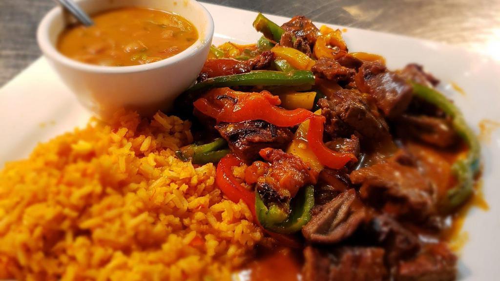 Guiso · Fajita beef simmered in red chile stew with tomatoes, jalapenos, and onions. Served with corn tortillas, rice and charro beans.