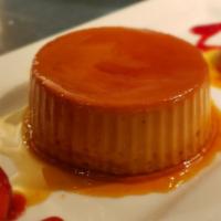 Flan · Creamy custard topped with strawberry sauce