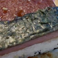 Spam Musubi · A slice of grilled spam on top of a block of rice. Wrapped together with dry seaweed.