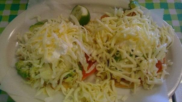 Tostadas · fried tortilla topped with refried beans, salad, sour cream, cheese and your choice of meat