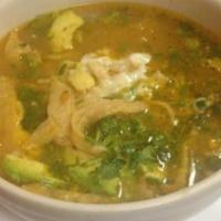Tortilla Soup · Served with fried corn tortillas, chicken, avocado, cilantro, and melted cheese.
