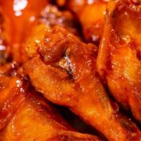 Chicken Wings · Deep fried wing tossed with your choice of house made sauces with a side of our in-house ran...