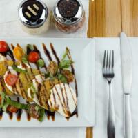 Caprese Salad · A bed of sliced mozzarella, fried green tomatoes & basil leaves drizzled with Balsamic vinegar