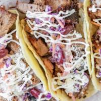 (3) Brisket Baja Tacos · Topped with slaw, dressing, parmesan and cilantro.
