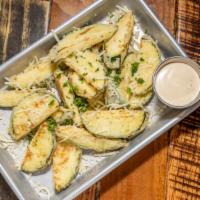 Fried Zucchini · Hand-battered zucchini slices lightly fried and served with a garlic Parmesan dipping sauce.
