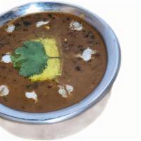 Dal Bukhara · Urad dal and kidney beans, simmered on slow heat for overnight, tempered with garlic, tomato...