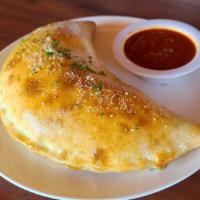 Calzone · All Calzones are filled with both ricotta and mozzarella cheeses and comes with a side of ma...
