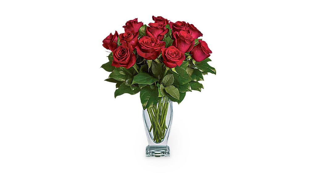 Teleflora'S Rose Classique - Dozen Red Roses · Red roses have symbolized love and romance for centuries. One need only gaze at a classic red rose arrangement, like this one, to see why. Red roses are stunning, dramatic, and they say so much - without saying a word. A dozen red roses with garden greens are hand-delivered in a fashionable couture vase. Classic and romantic.