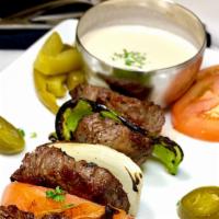 Steak Kabob Meat · Tender Steak grilled to perfection, served with pickles, tomatoes and onions topped with tah...