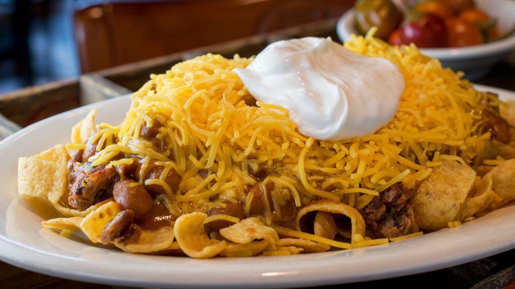 Regular Frito Pie · Fritos, chopped brisket, Bar-B-Q sauce, your choice of ranch or pinto beans, cheese, and sour cream served on the side.