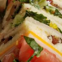 Club Sandwich · Ham, turkey, bacon, romaine lettuce, tomato, cheddar & swiss cheese on Texas Toast.  Served ...