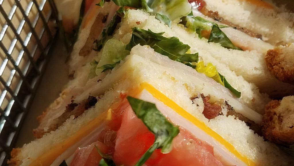 Club Sandwich · Ham, turkey, bacon, romaine lettuce, tomato, cheddar & swiss cheese on Texas Toast.  Served with a pickle spear.