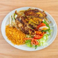 Grilled Fish · Grilled fish with onions, bell peppers, rice & salad.