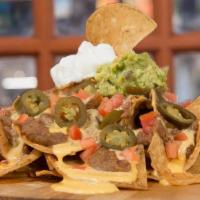 Loaded Stacked Nachos · Tortilla chips covered with Beef or Chicken, refried beans, fresh guacamole, sour cream, jal...