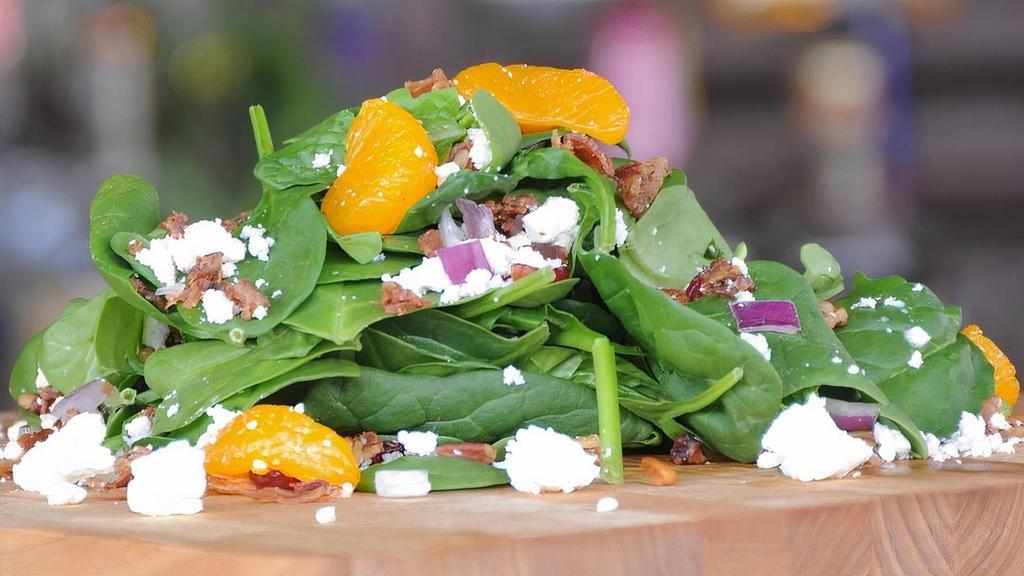 Original Baby Spinach Salad · Fresh Baby Spinach, feta cheese crumbles, Applewood Smoked Bacon, Craisins, red onions, homemade roasted pecans, mandarin oranges & raspberry vinaigrette