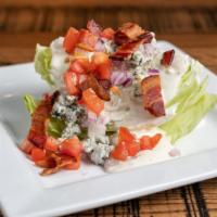 The Wedge · Iceberg wedge topped with buttermilk Bleu cheese dressing, applewood bacon, diced tomatoes, ...