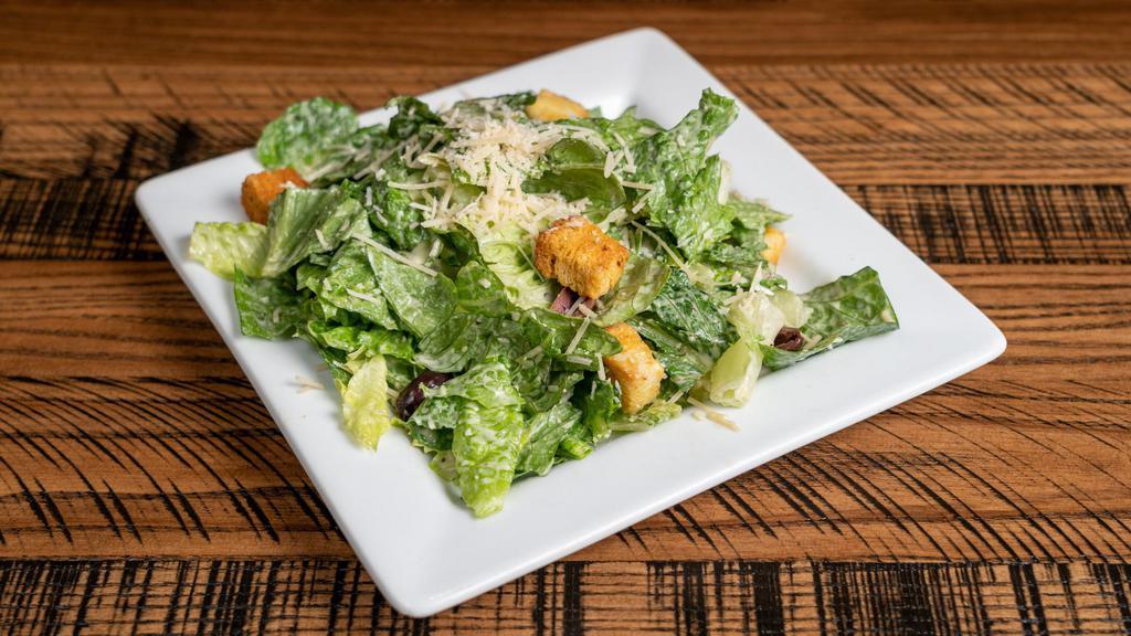 Side Caesar Salad · Romaine lettuce tossed with caesar dressing, Parmesan cheese, Kalamata olives and house-made croutons.