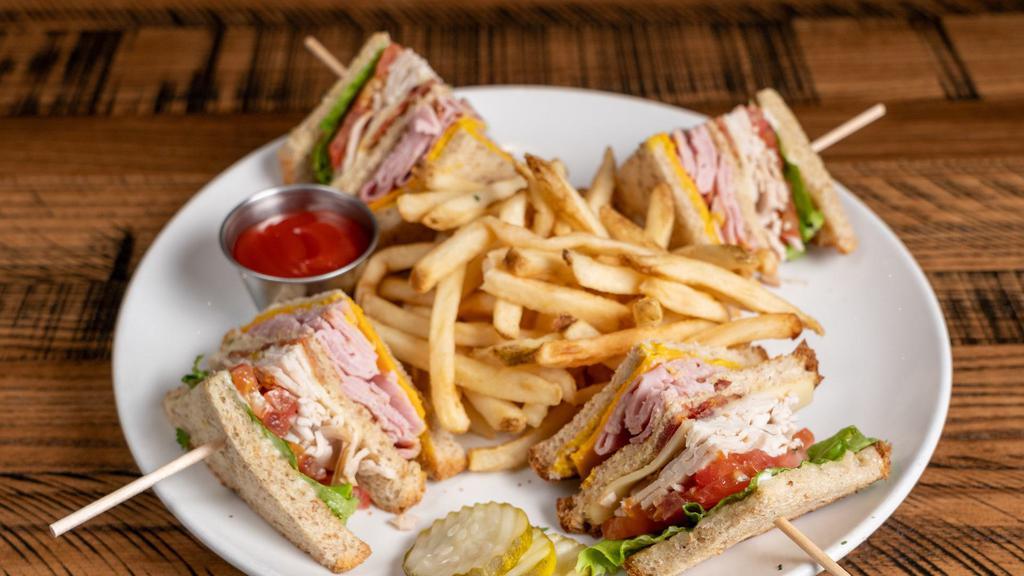 The Club Sandwich · Black forest ham, smoked turkey, Monterey Jack and Cheddar cheese, applewood bacon, lettuce, tomato, mayo and mustard on wheatberry bread.