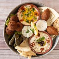 Mazza · This sampler plate comes with hummus, baba ghannog, falafel (four), kibbeh (two), dolma (fou...